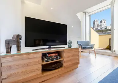 a living room with a large flat screen tv at Mouzinho da Silveira Unique Apartments, by Oporto Collection in Porto