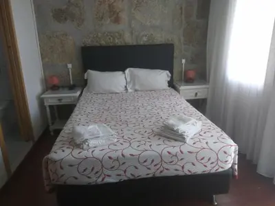 a bedroom with a bed with two towels on it at PORTO RICO STUDIOS in Porto