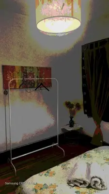 a bedroom with a large tv and a lamp at AL- Almada 4 in Porto
