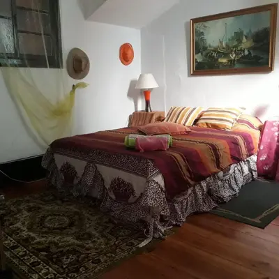 a bedroom with a bed with a blanket on it at AL- Almada 4 in Porto