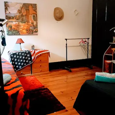 a bedroom with a dresser with an american flag on it at AL- Almada 4 in Porto