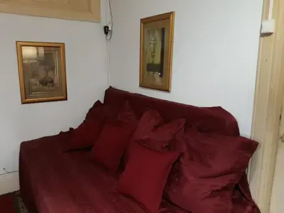 a red couch with red pillows in a room at AL-Almada-2 in Porto