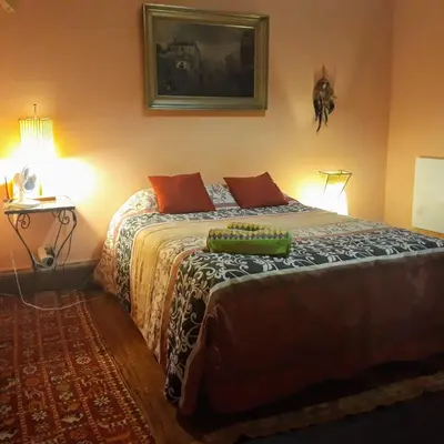 a bedroom with a bed and a table with a lamp at AL-Almada-2 in Porto