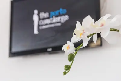 a bouquet of white flowers in front of a television at GuestReady - Red Stripes in Porto