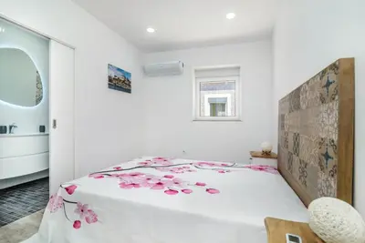 a bedroom with a bed with pink flowers on it at Maredimo Village Porto Casa 5 in Porto
