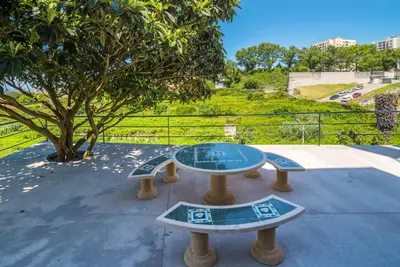 a table and benches in a park with a tree at Maredimo Village Porto Casa 5 in Porto
