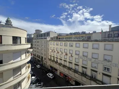 a window with a view of a large building at Aliados Downtown Studio by Porto City Hosts in Porto