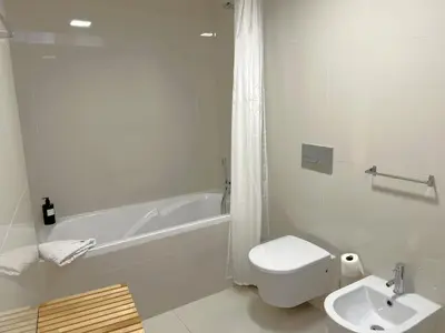 a bedroom with a bed with a mirror and two chairs at Aliados Downtown Studio by Porto City Hosts in Porto