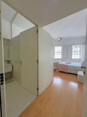 a bedroom with a white bed with two towels on it at Aliados Downtown Studio by Porto City Hosts in Porto