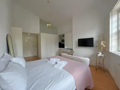 a kitchen with white cabinets and a microwave at Aliados Downtown Studio by Porto City Hosts in Porto