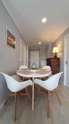 a dining room with a table and white chairs at Gaiapart in Vila Nova de Gaia