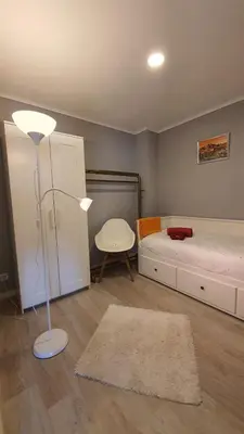 a bedroom with a bed and a lamp and a chair at Gaiapart in Vila Nova de Gaia