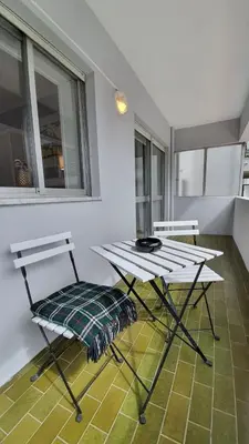 a table and two chairs in a room with a table at Gaiapart in Vila Nova de Gaia