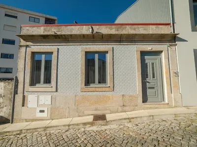 a bathroom with a toilet and a sink and a mirror at OPORTO GUEST - Maia House in Porto