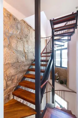 a staircase in a house with a stone wall at ON Apartments - Center in Porto