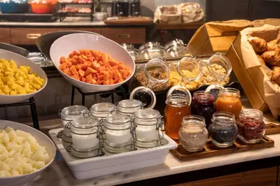 a group of jars of nuts and honey on a table at Fontinha Porto, Trademark Collection by Wyndham in Porto