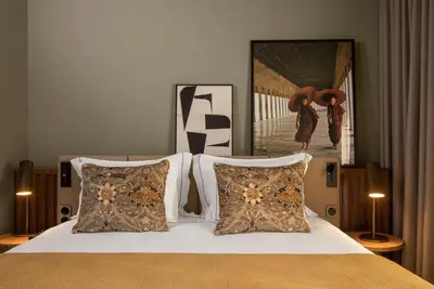 a bedroom with a bed and a large window at Fontinha Porto, Trademark Collection by Wyndham in Porto