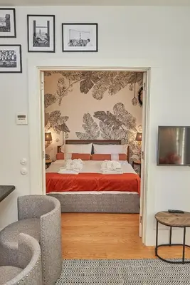 a bedroom with a bed with red sheets and a chair at BOUTIQUE Rentals-Flores Classic historical centre in Porto