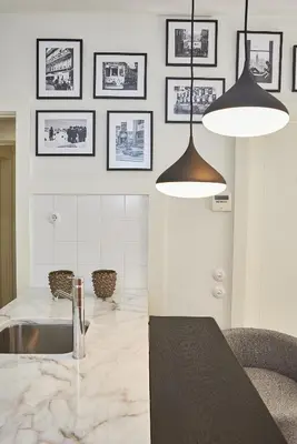 a kitchen with two lights and a marble counter top at BOUTIQUE Rentals-Flores Classic historical centre in Porto