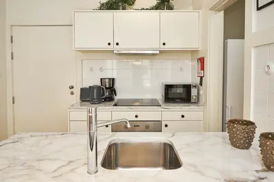 a kitchen with a sink and a microwave at BOUTIQUE Rentals-Flores Classic historical centre in Porto