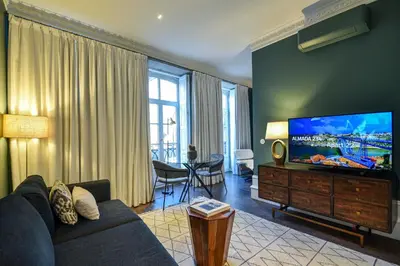a kitchen and living room with a table and chairs at Almada 234 in Porto