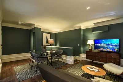 a bedroom with a bed and a chair and a lamp at Almada 234 in Porto