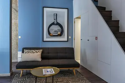 a living room with a table and chairs and a couch at Almada 234 in Porto