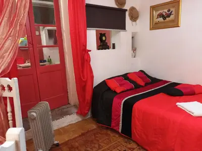 a bed with butterflies on a curtain in a room at AL-Pinheiro 62 in Porto