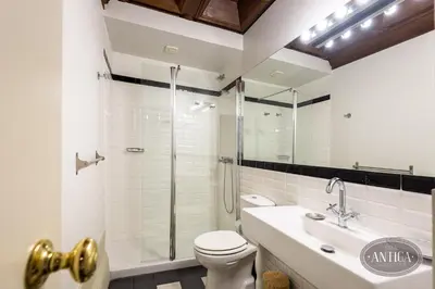 a bathroom with a shower and a toilet and a sink at Casa Antiga in Porto