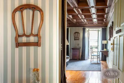 a hallway with striped walls and a chair in a room at Casa Antiga in Porto
