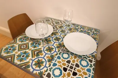 a table with two glasses and plates on a table at FLH Porto Traditional Studio with Terrace in Porto
