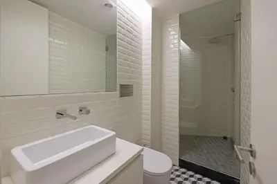 a white bathroom with a sink and a shower at FLH Porto Traditional Studio with Terrace in Porto