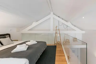 a bedroom with a bed with a glass wall at GuestReady - Cosy living in downtown in Porto