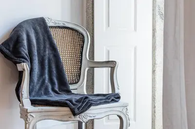 a black blanket on the back of a chair at GuestReady - Cosy living in downtown in Porto