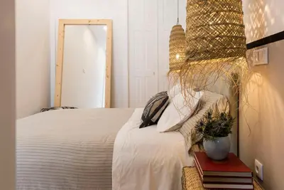 a bedroom with a bed and a table with a plant at GuestReady - The Dukes Retreat E in Porto
