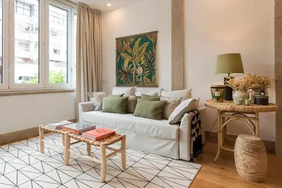 a living room with a white couch and a table at GuestReady - The Dukes Retreat E in Porto