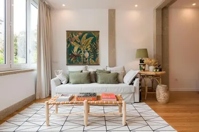 a living room with a white couch and a table at GuestReady - The Dukes Retreat E in Porto