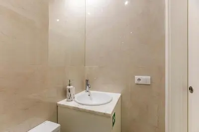 a bathroom with a sink and a toilet at LovelyStay - Cozy 1BR in Santa Catarina w/ Balcony in Porto