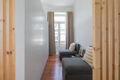 a living room with a couch and a chair at Oportments - S.Bento in Porto