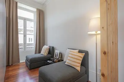 a living room with a couch and a chair at Oportments - S.Bento in Porto