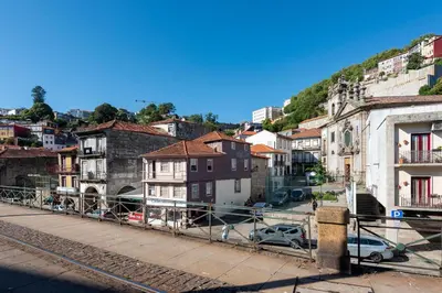 a city with buildings and cars on a street at Prime Riverside in Porto