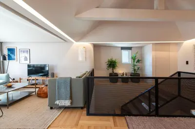 a living room with a couch and a table at Prime Riverside Duplex in Porto