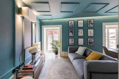 a living room with blue walls and a couch at Ribeira Old Town Charming Flat w/ AC by LovelyStay in Porto