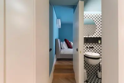 a room with a bedroom with a bed and a door at Ribeira Old Town Charming Flat w/ AC by LovelyStay in Porto
