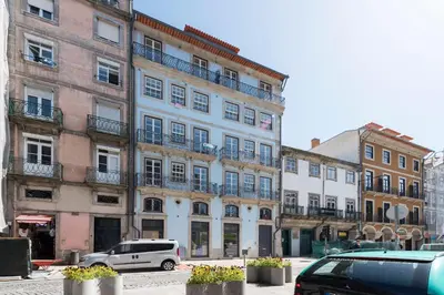 a large building with cars parked in front of it at Ribeira Old Town Charming Flat w/ AC by LovelyStay in Porto