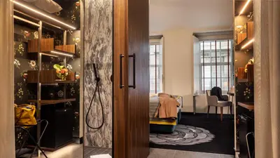 a dressing room with a bed and a dressing table at Pousada do Porto - Rua das Flores in Porto