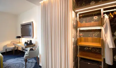 a hotel room with a desk and a television at Pousada do Porto - Rua das Flores in Porto