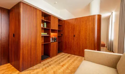 a living room with wood paneling and a couch at Ceuta Terrace Suites in Porto