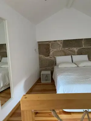 a bedroom with a bed and a mirror at My Little Porto - Charming house in Miragaia, Porto in Porto