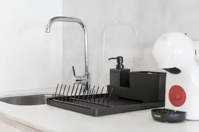 a kitchen counter with a sink with a faucet at GuestReady - Private oasis for two in Porto
